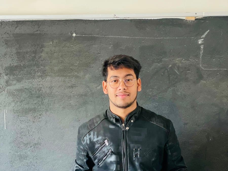 A young teacher at a classroom podium